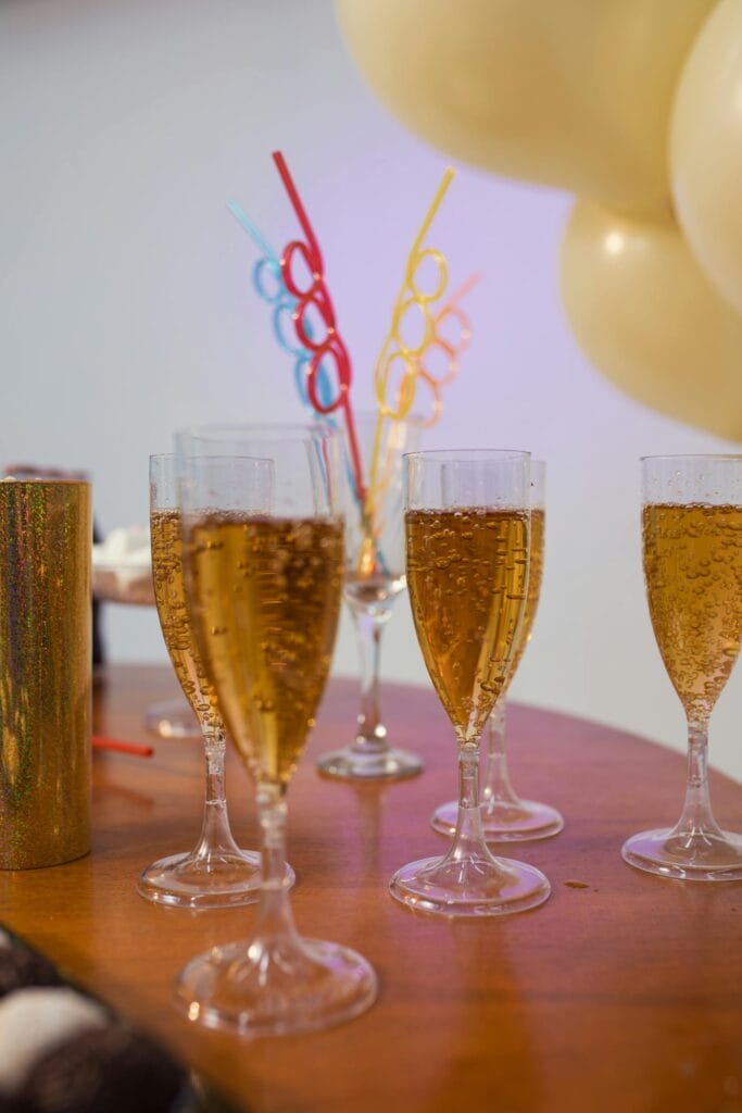 A festive table setting with sparkling drinks and colorful straws for a Brazilian celebration.