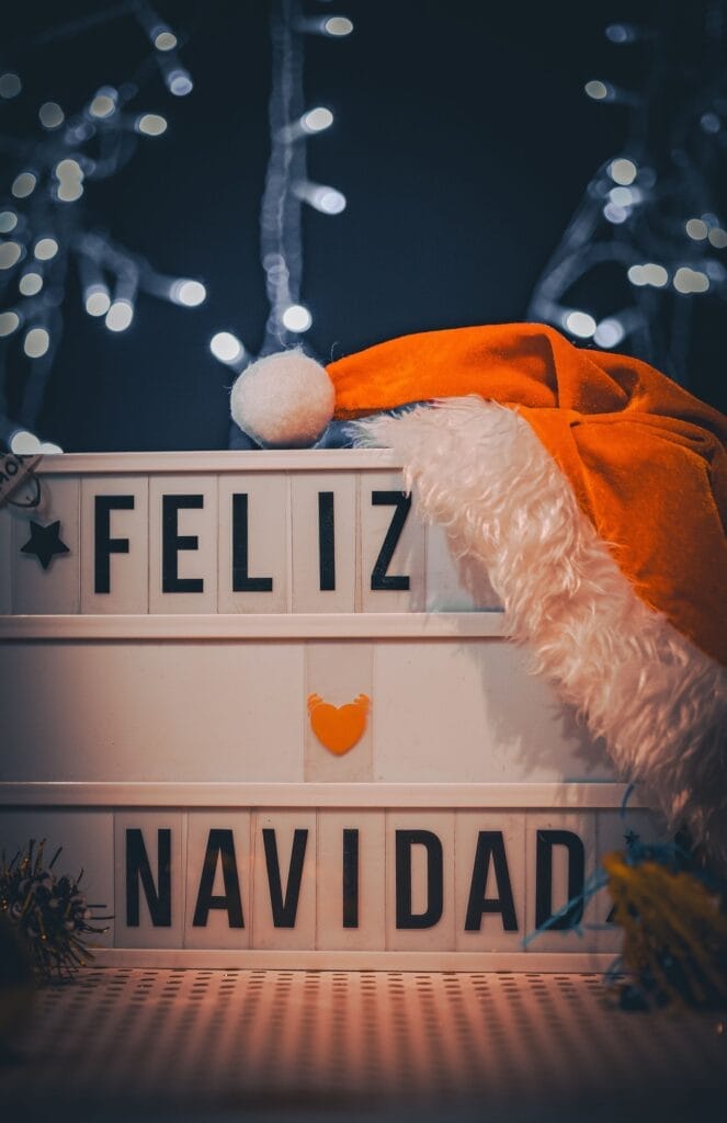 Christmas-themed decoration with 'Feliz Navidad' sign and Santa hat, ideal for holiday images.